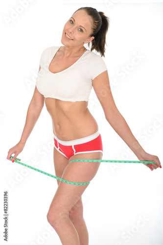 Healthy Young Woman Checking Her Weight Loss With a Tape Measure
