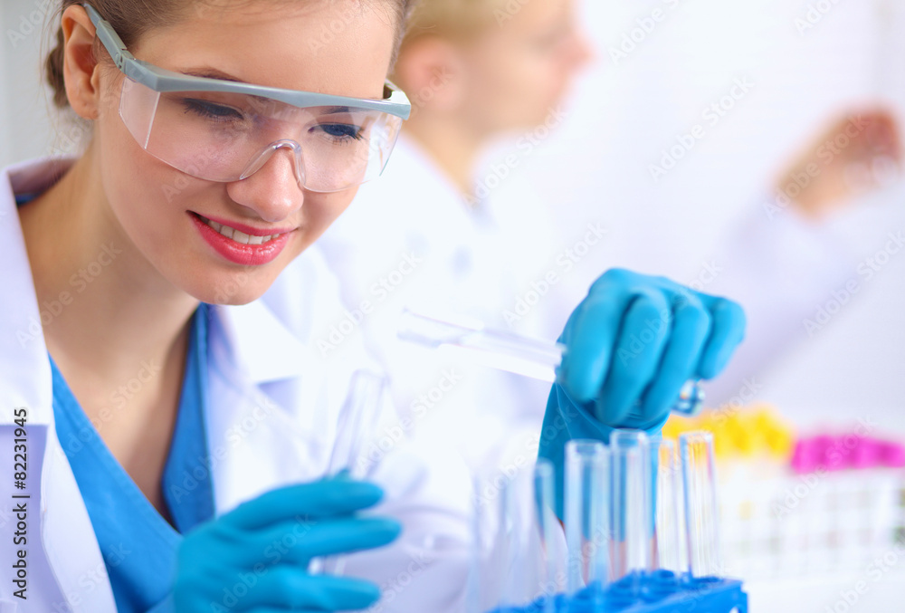 Woman researcher is surrounded by medical vials and flasks Woman researcher is surrounded by medical vials and flasks