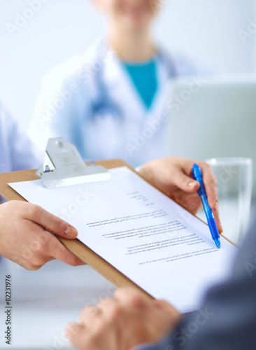 Medical team sitting at the table in modern hospital