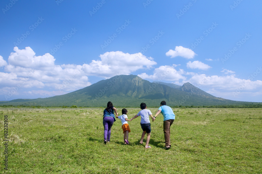 Happy family running to the mountain