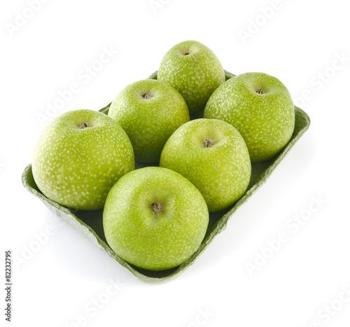 Granny Smith apples in a tray on a white background..