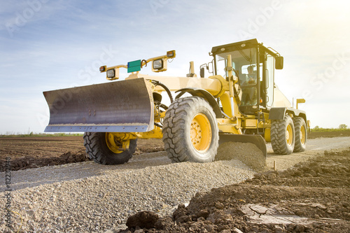 Photos Grader working on gravel leveling