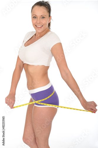 Healthy Young Woman Checking Her Weight Loss With a Tape Measure © Martin Lee