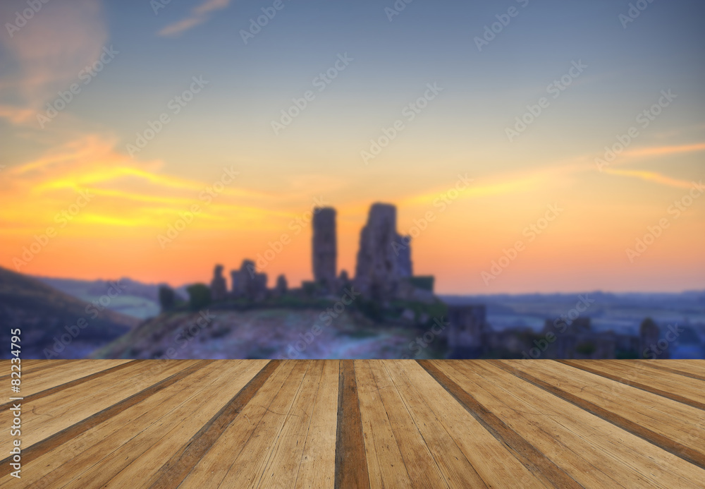 Corfe Castle Winter sunrise pre-dawn colourburst with wooden pla Corfe Castle Winter sunrise pre-dawn colourburst with wooden pla