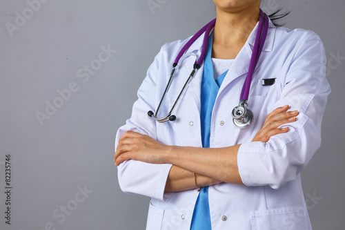 Young woman doctor standing  with crossed arms