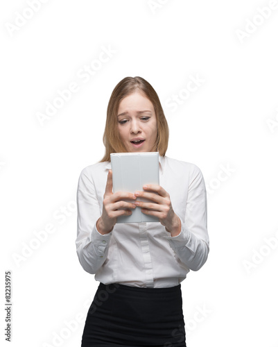 Young business lady is looking at the tablet. 