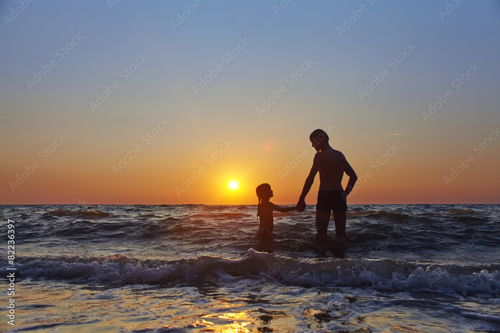 father and daughter at sunset