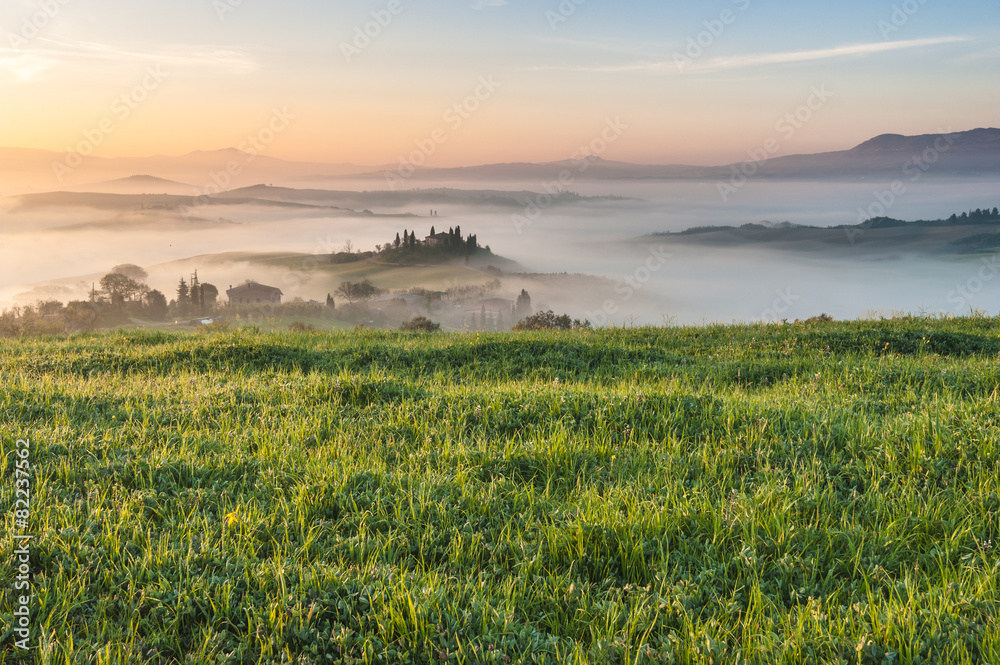 Mist flowing in the green fields of Tuscany