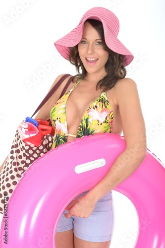 Young Woman Wearing a Swim Suit on Holiday Carrying a Rubber Ri