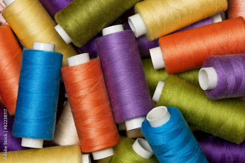 background from multi-colored spools of thread background from multi-colored spools of thread