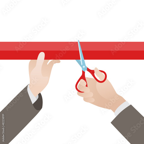 Hand with scissors cut the red ribbon
