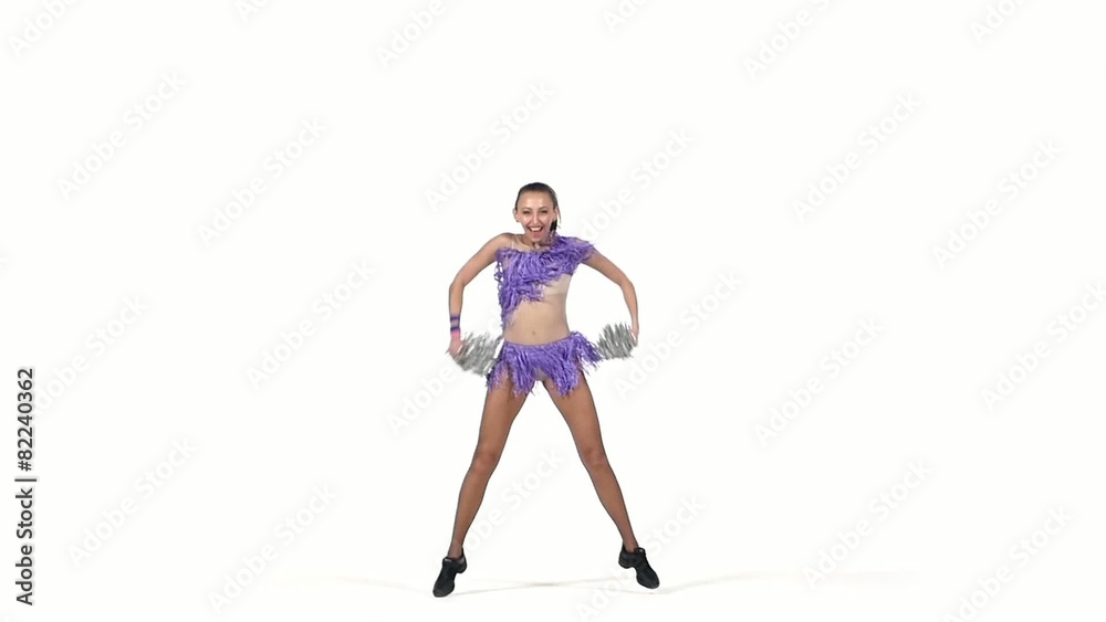 Young cheerleader with pom-poms smiling at camera, slow motion
