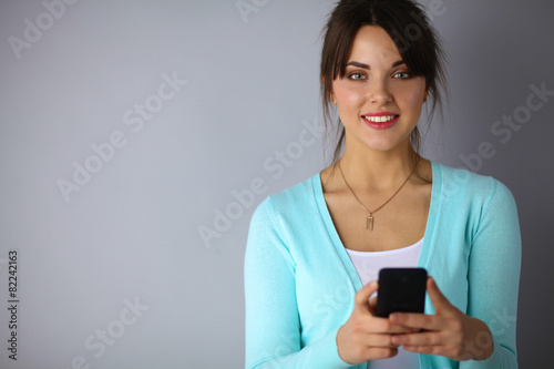 Woman using and reading a smart phone