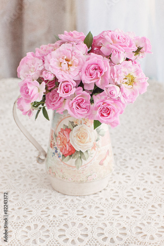 Beautiful fresh pink roses on a table. light background. © ulchik74