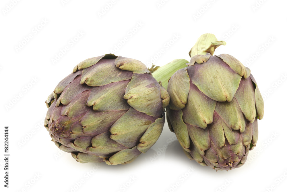 Fototapeta premium two freshly cut artichoke halves on a white background