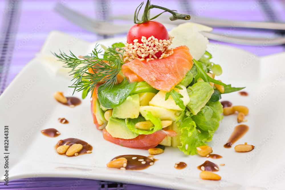 Round shaped Smocked salmon salad with avocado decorated with ch