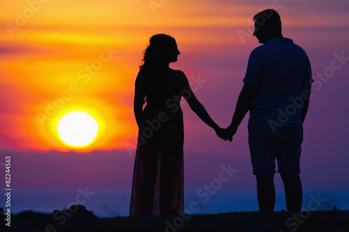 silhouette of couple at beautiful sunset background