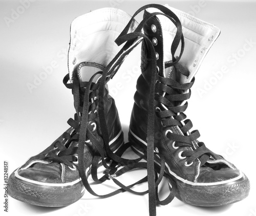 A pair of black canvas sneakers on white background