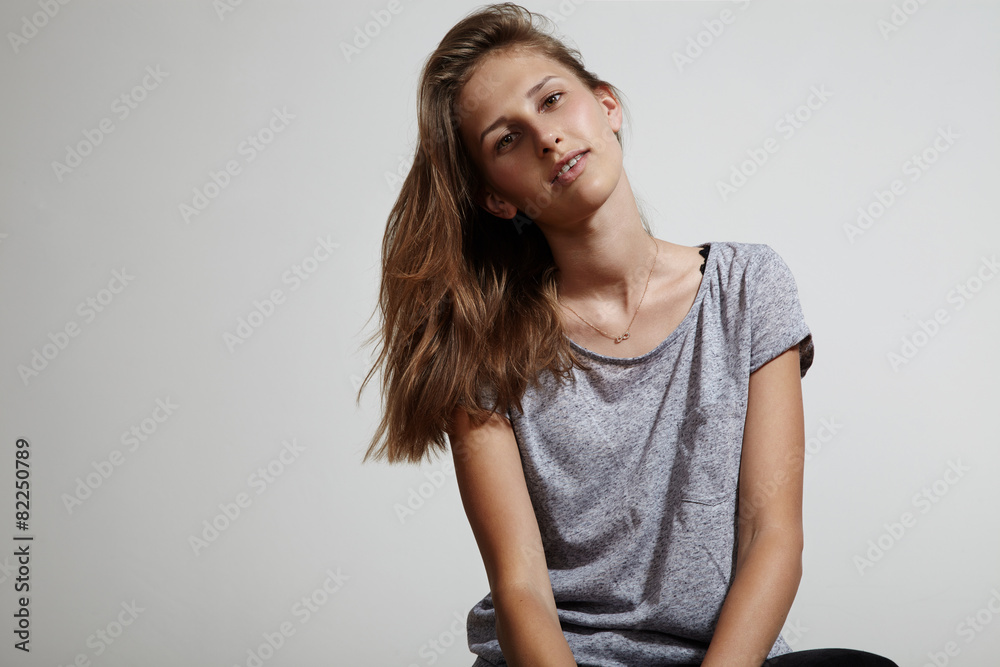 prety girl wearing grey casual t-shirt, smiling, brackets.