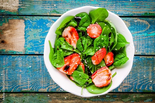 salad with spinach and strawberries, balsamic sauce and sesame