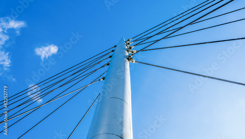 Pylon with guy wires against a blue sky