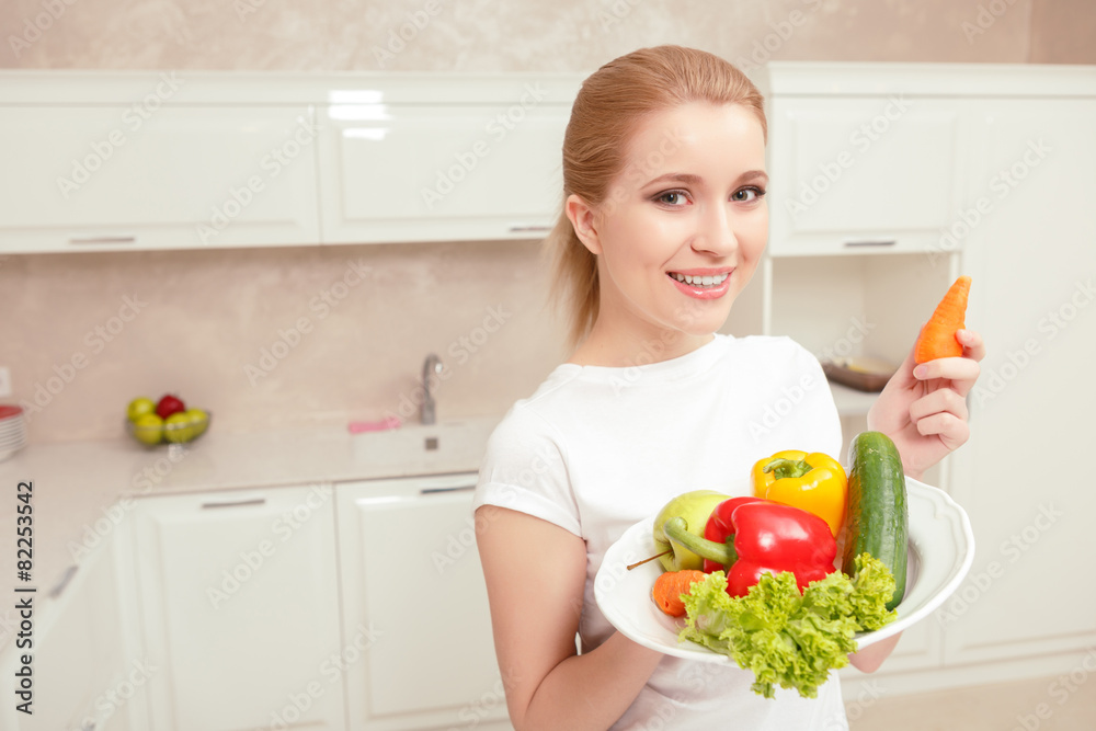 Woman holds plate with vegetables Woman holds plate with vegetables