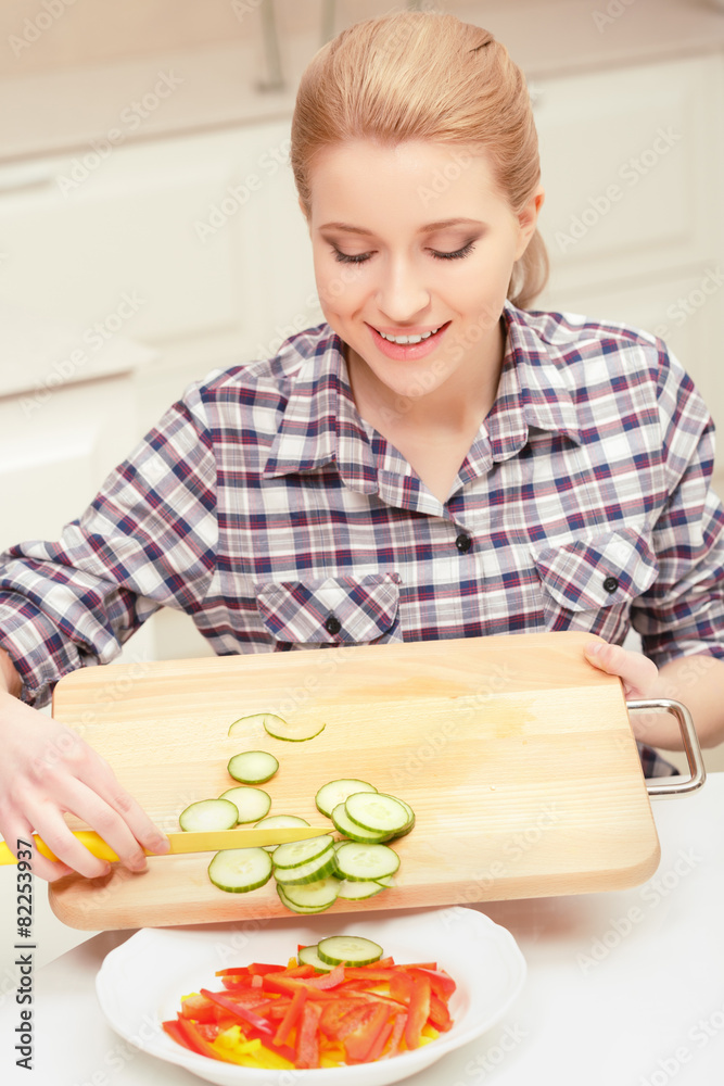 Woman makes salad of fresh vegetables Woman makes salad of fresh vegetables