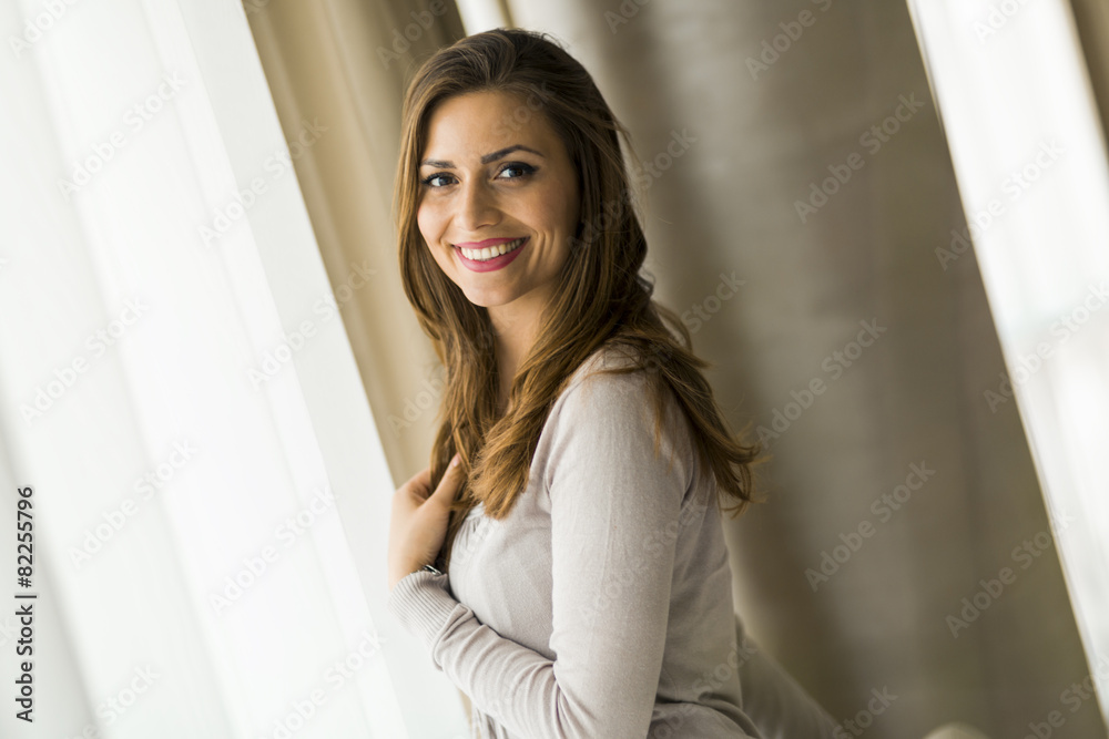 Beautiful and successful brunette posing in front of a window Beautiful and successful brunette posing in front of a window