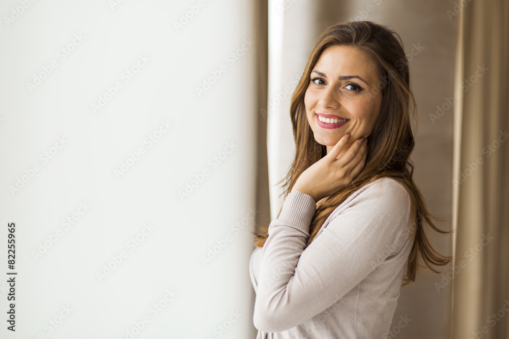 Beautiful and successful brunette posing in front of a window Beautiful and successful brunette posing in front of a window