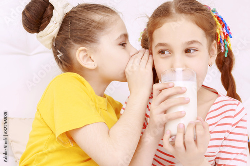 Bright dressed children drinking milk