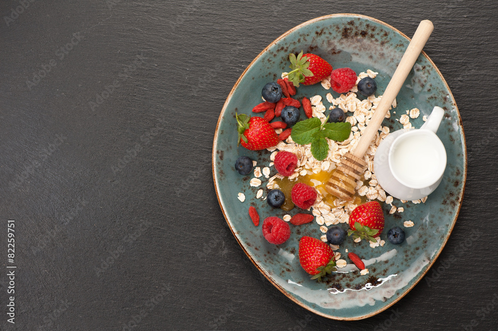 Fototapeta premium Oatmeal with berries. top view