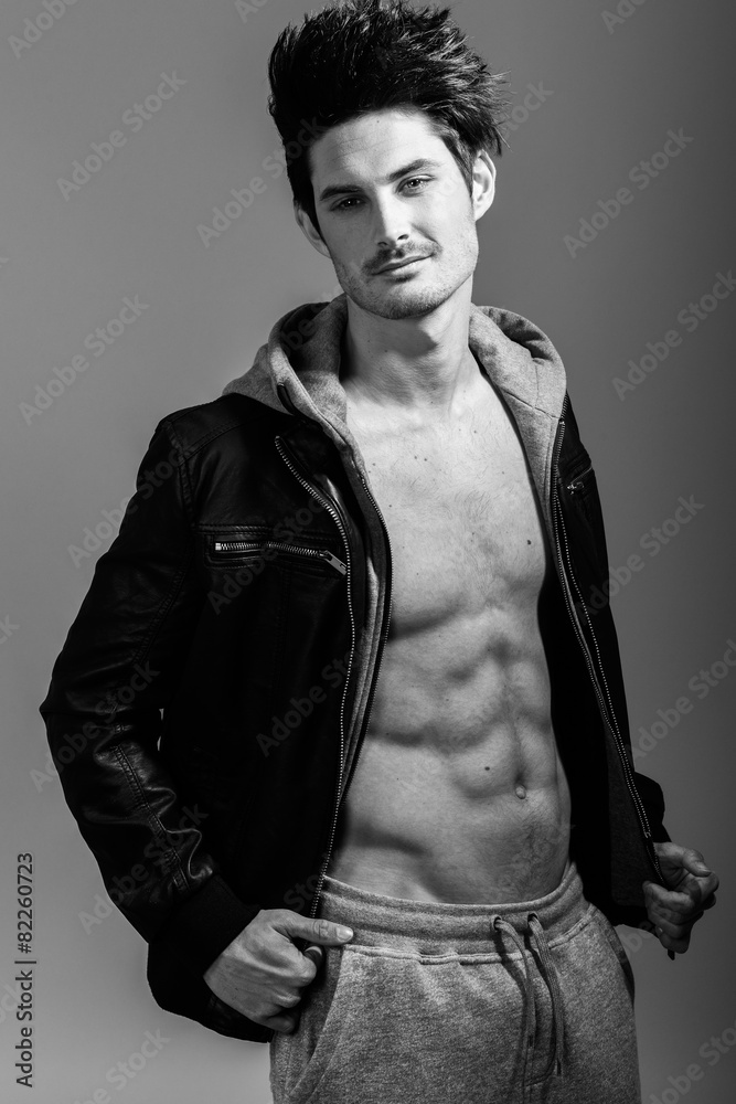 Athletic man wearing hoodie jacket. Studio shot Athletic man wearing hoodie jacket. Studio shot