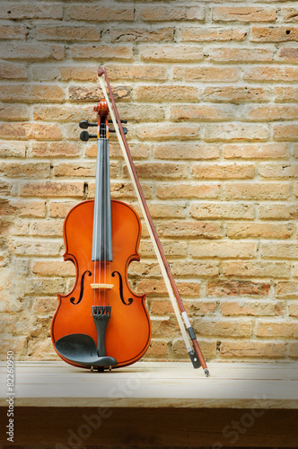 Still life violin with brick wall. © peerayot