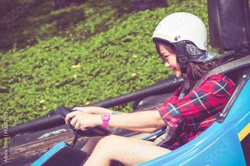 Cute Thai girl is driving Go-kart in retro color