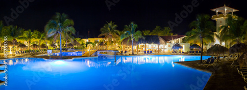 Panorama of hotel and swimming pool at night, photo