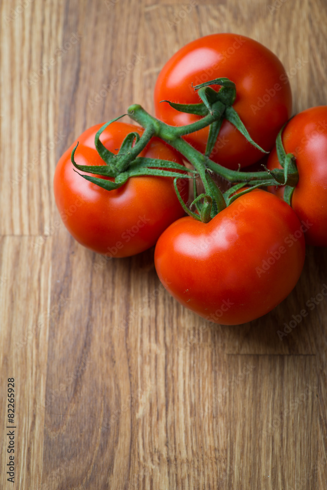Fresh and tasty tomatoes on a wooden table Fresh and tasty tomatoes on a wooden table