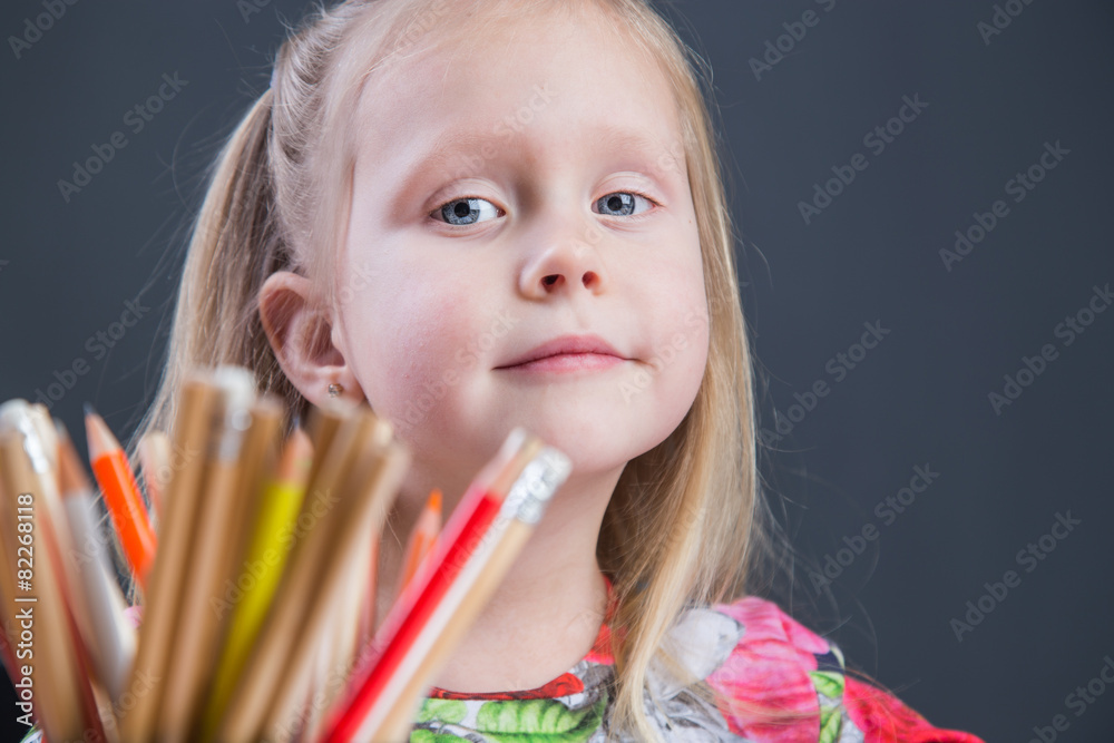 Small young girl drawing pictures with pencils Small young girl drawing pictures with pencils