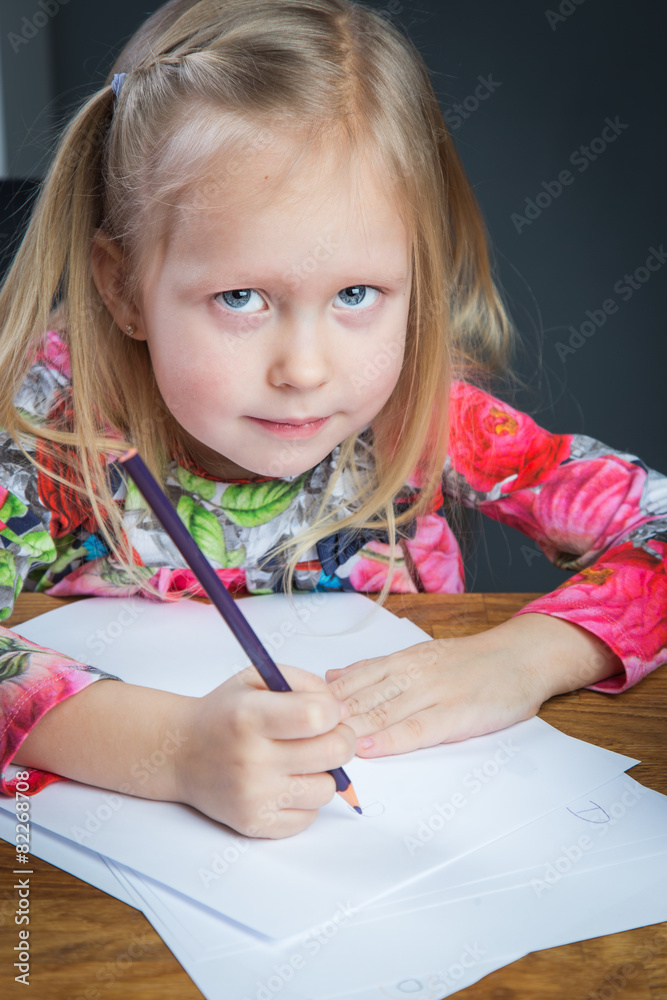 Small young girl drawing pictures with pencils Small young girl drawing pictures with pencils
