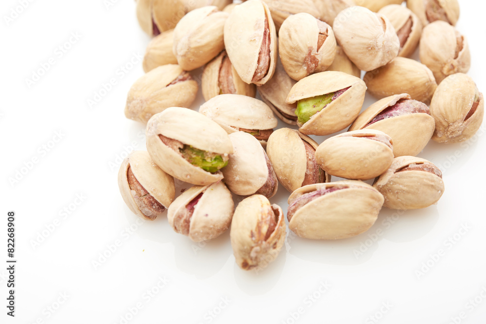 Heap of pistachios nuts isolated on the white