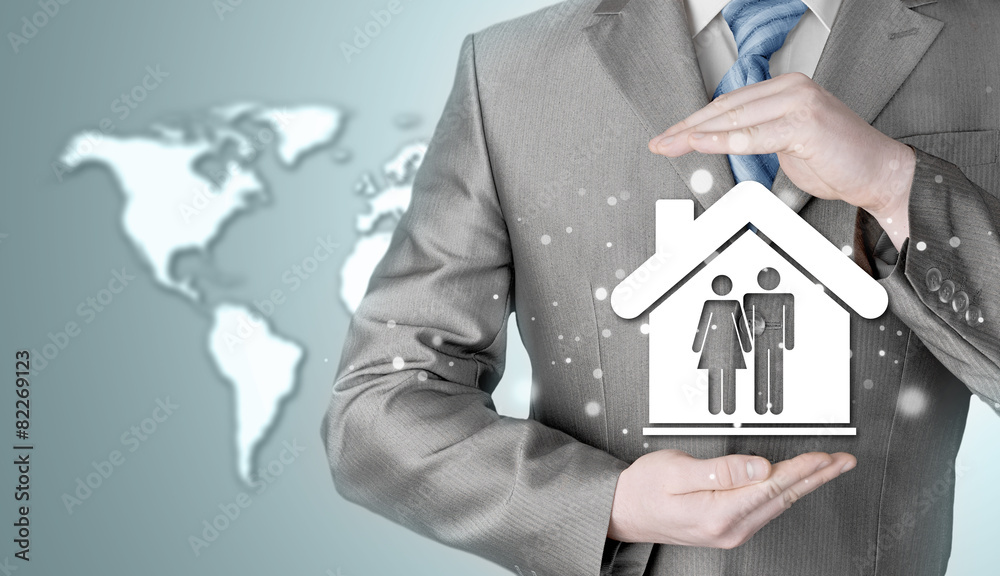 businessman protecting family in home with hands businessman protecting family in home with hands