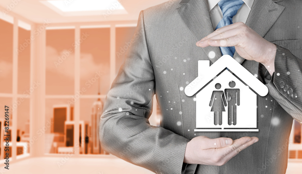 businessman protecting family in home with hands