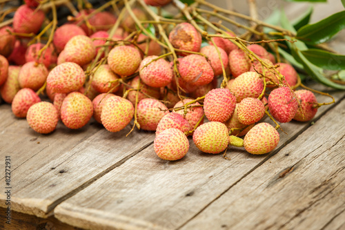 Red litchi on wooden floor