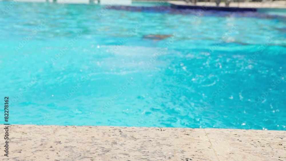 Male Swimmer Jumping Off The Starting Block Into The Pool Male Swimmer Jumping Off The Starting Block Into The Pool