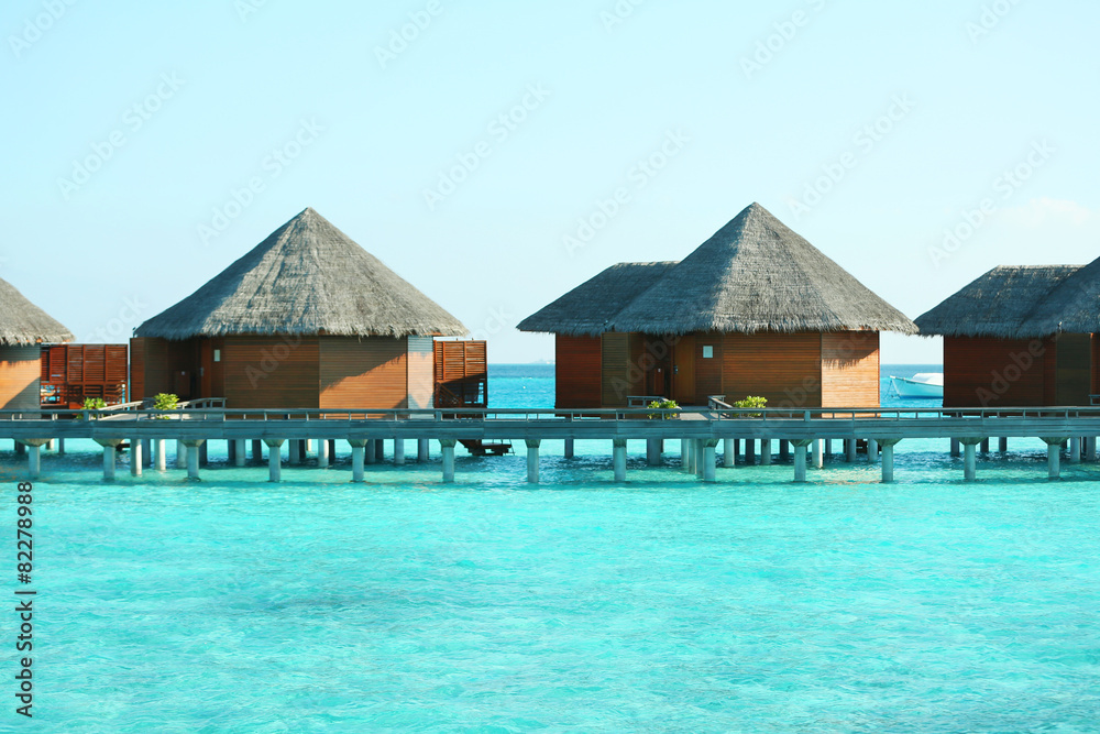 Water villas over ocean background, in resort