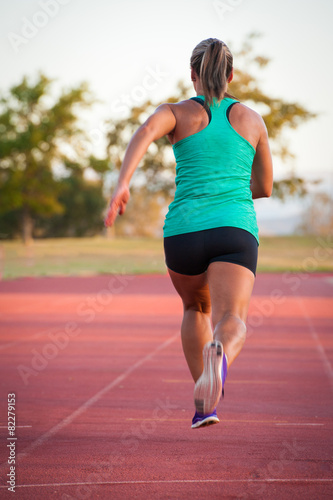 Female runner on an athletics track © danedwards