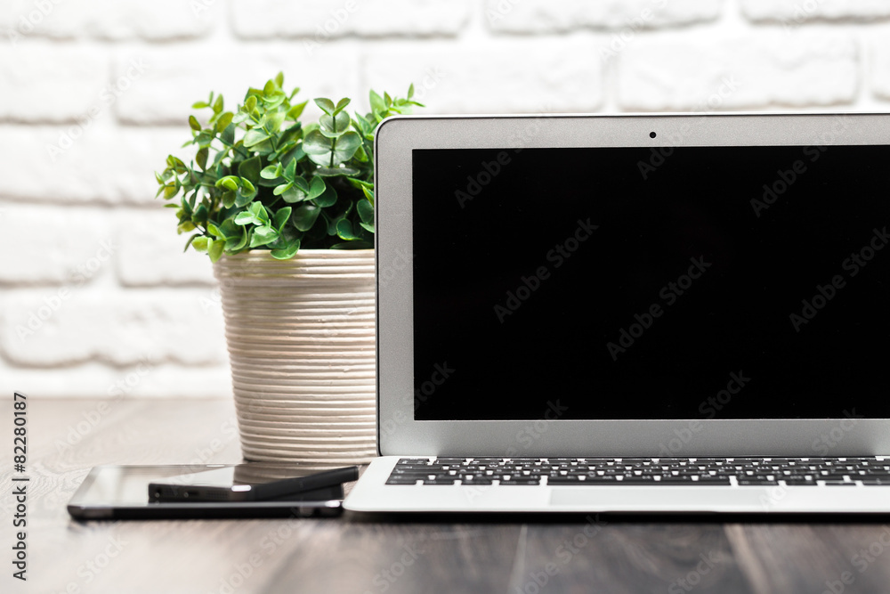Fototapeta premium Open laptop on a wooden desk