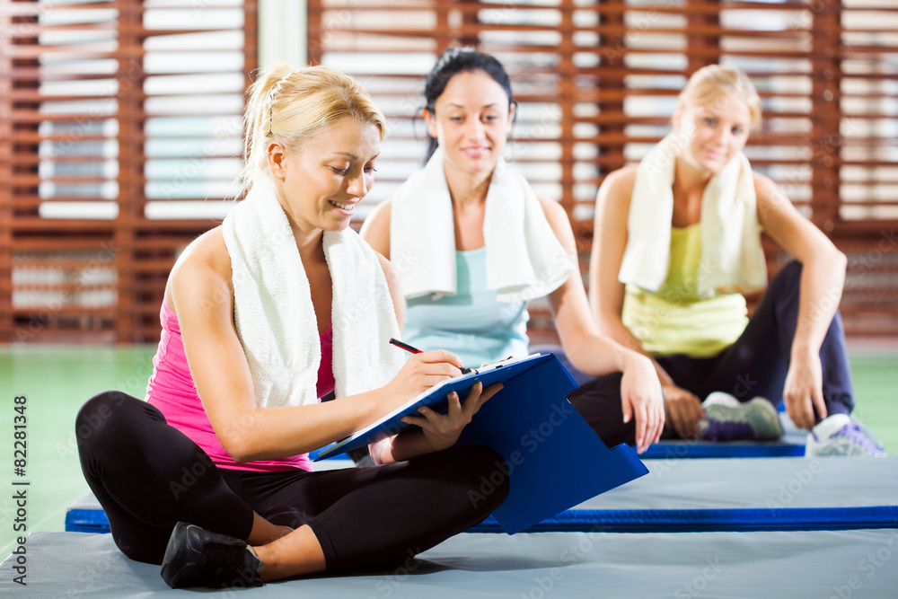 Fitness instructor is making plan for exercise Fitness instructor is making plan for exercise