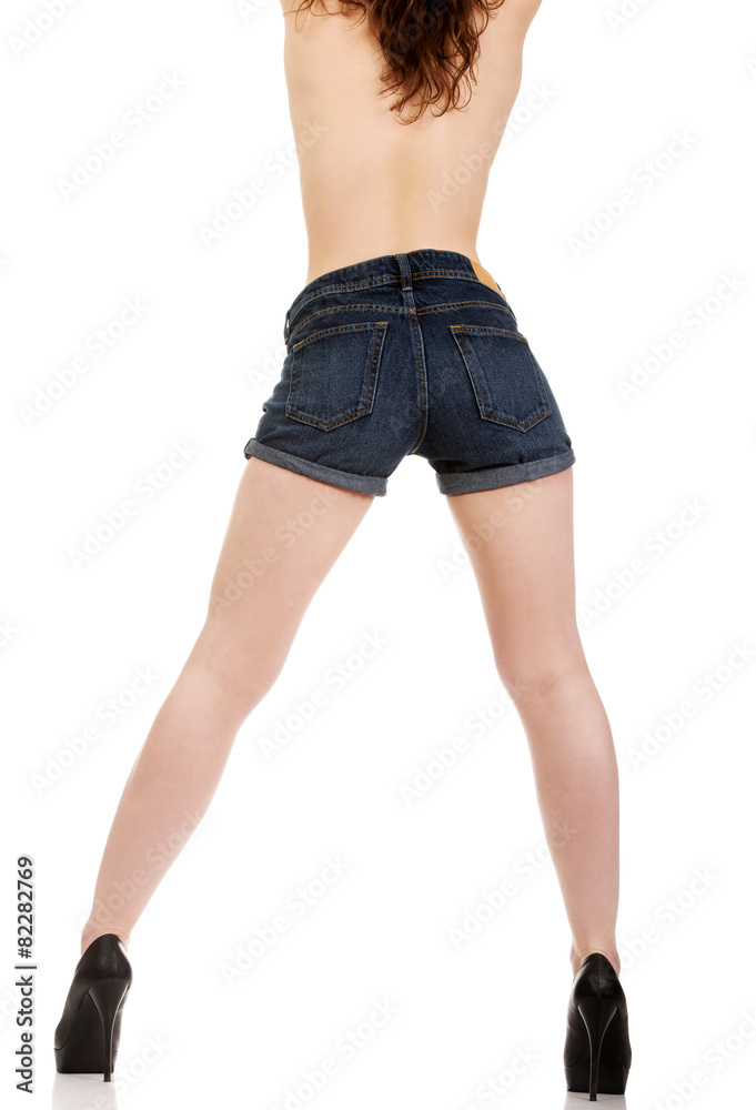 Shirtless woman in jeans shorts.