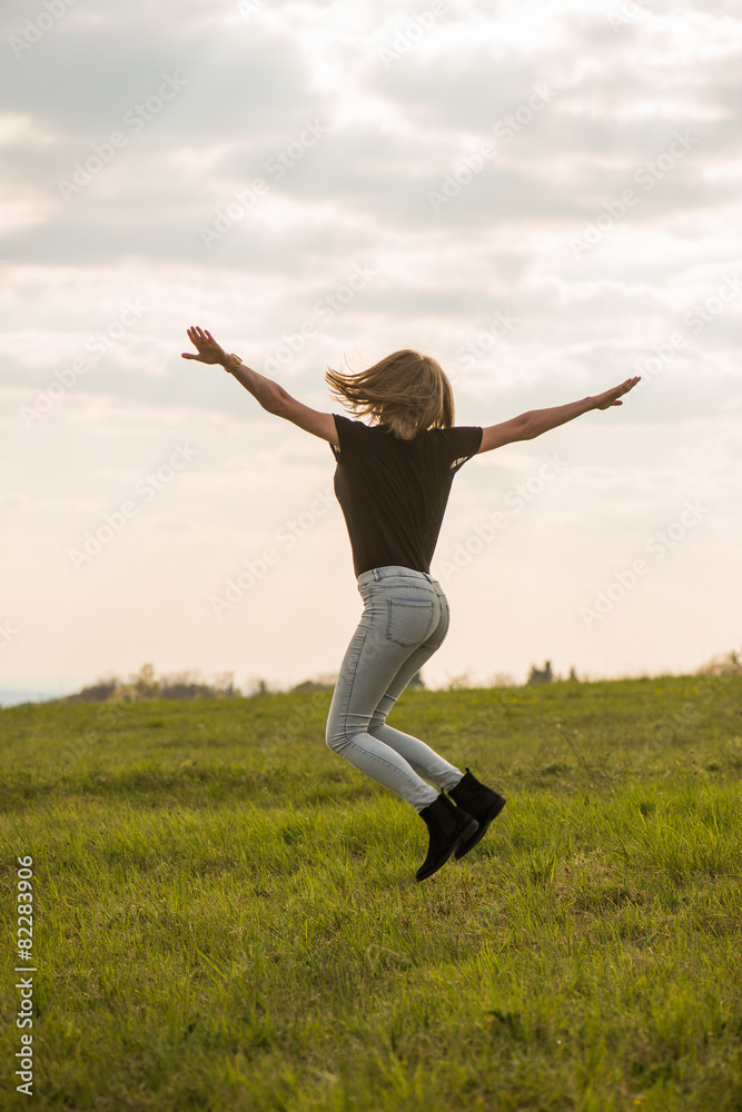 Happy Young Woman Jumping over blue sky Happy Young Woman Jumping over blue sky