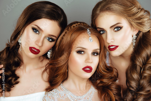 Portrait of three Beautiful Women with Fashion Make-Up and Hair